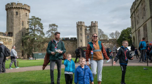 Family walking outside Warwick castle